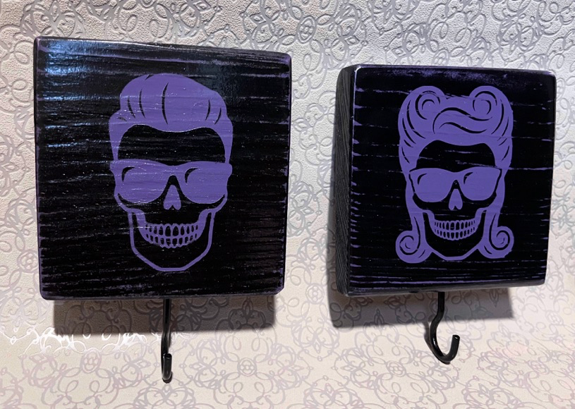 Bruno and Brigitte skull key holders, dark wood with purple skull graphic